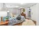 A cozy bedroom with stylish furnishings including a dresser and a faux fur rug on hardwood floor at 2663 King St, Denver, CO 80211