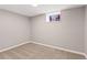 Small finished basement bedroom with carpet and a window at 2663 King St, Denver, CO 80211