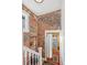 Charming entryway features exposed brick and a wood door, leading to the upper level at 2663 King St, Denver, CO 80211