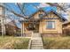 Charming home with brick facade, inviting front porch, and well-manicured lawn at 2663 King St, Denver, CO 80211