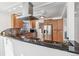 Modern kitchen features stainless steel appliances, black countertops, and wooden cabinets at 2663 King St, Denver, CO 80211