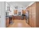 Well-lit kitchen boasts stainless steel appliances, wood cabinets, and lots of counter space at 2663 King St, Denver, CO 80211
