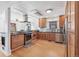 Eat-in kitchen with stainless steel appliances and warm wood cabinets at 2663 King St, Denver, CO 80211