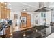 Bright kitchen with stainless steel fridge, wooden cabinets, granite countertops, and modern appliances at 2663 King St, Denver, CO 80211