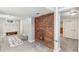 Basement room features brick accent wall, carpet, and neutral wall color and trim at 2663 King St, Denver, CO 80211