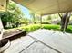 View of covered patio area with concrete flooring and spacious green lawn for outdoor enjoyment at 6040 W Elmhurst Dr, Littleton, CO 80128