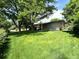 Expansive backyard with lush green lawn and mature trees, perfect for outdoor activities and relaxation at 6040 W Elmhurst Dr, Littleton, CO 80128