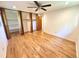 Bedroom features hardwood flooring, ceiling fan, and large closets at 6040 W Elmhurst Dr, Littleton, CO 80128