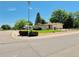 Inviting home on a corner lot with well-manicured lawn and mature trees creating a serene atmosphere at 6040 W Elmhurst Dr, Littleton, CO 80128