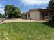 Charming ranch-style home with well-maintained lawn and gravel driveway, showcasing curb appeal at 6040 W Elmhurst Dr, Littleton, CO 80128