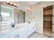 Modern bathroom with double sinks, white cabinets, and a separate tub for a luxurious feel at 8555 Hotchkiss St, Littleton, CO 80125