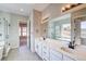 Beautiful bathroom featuring double sinks, a large mirror, a separate tub, and tiled floors at 8555 Hotchkiss St, Littleton, CO 80125