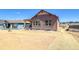 A new single-story home featuring board and batten siding and a xeriscaped front yard under a blue sky at 8555 Hotchkiss St, Littleton, CO 80125