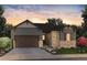 Charming home featuring a stone and siding exterior, lush landscaping, and a two-car garage at 8555 Hotchkiss St, Littleton, CO 80125