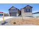 Beautiful front of this home showcasing a modern exterior, a two car garage and xeriscaping at 8555 Hotchkiss St, Littleton, CO 80125