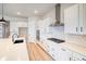 Modern kitchen with white cabinets, stainless steel appliances, and a large island for ample counter space at 8555 Hotchkiss St, Littleton, CO 80125