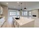 Open concept kitchen and living space featuring a large center island and stainless steel appliances at 8555 Hotchkiss St, Littleton, CO 80125