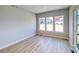 Bright living room features beautiful wood floors and large windows, filling the space with natural light at 8555 Hotchkiss St, Littleton, CO 80125