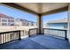 Covered patio with a dark stained railing offering community views on a sunny day at 8555 Hotchkiss St, Littleton, CO 80125