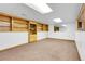 Finished basement showcasing carpet and built-in wooden shelving with storage cabinets at 10142 Josephine St, Thornton, CO 80229