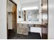 Bathroom featuring single sink vanity, mirror, and open access to main bedroom at 10142 Josephine St, Thornton, CO 80229
