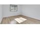 Well-lit bedroom featuring a window, neutral paint, and wood-look flooring at 10142 Josephine St, Thornton, CO 80229
