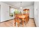 Dining room featuring a wooden table, chairs, chandelier, and a large window providing lots of natural light at 10142 Josephine St, Thornton, CO 80229