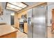 Efficient kitchen design with stainless steel appliances, bright wood cabinets, and an open layout for easy meal preparation at 10142 Josephine St, Thornton, CO 80229