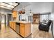 The open-concept kitchen features wood cabinets, stainless steel appliances, and flows seamlessly into the living area at 10142 Josephine St, Thornton, CO 80229
