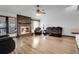 Bright living room featuring a brick fireplace, ceiling fan, and hardwood floors, creating an inviting and relaxing space at 10142 Josephine St, Thornton, CO 80229