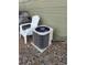 Exterior shot of an air conditioning unit outside the home, next to a white chair at 2008 S Hannibal St # A, Aurora, CO 80013