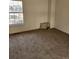 Cozy bedroom featuring neutral carpeting, a window for natural light, and ample space at 2008 S Hannibal St # A, Aurora, CO 80013