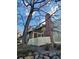 Charming home featuring a brick chimney, inviting red door, and white picket fence at 2008 S Hannibal St # A, Aurora, CO 80013