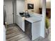 Functional kitchen area with stainless steel dishwasher, stylish countertops, and modern flooring at 2008 S Hannibal St # A, Aurora, CO 80013