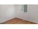 Cozy bedroom featuring hardwood-style floors and a window at 2832 S Mobile St, Aurora, CO 80013