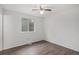 Bedroom featuring hardwood-style floors, a ceiling fan, and a window at 2832 S Mobile St, Aurora, CO 80013
