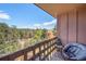 Relaxing balcony view with chair, table, and picturesque mountain scenery at 30819 Hilltop Dr, Evergreen, CO 80439
