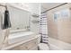 Bright bathroom featuring a modern vanity with vessel sink and shower with stylish striped curtain at 30819 Hilltop Dr, Evergreen, CO 80439