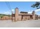 Charming exterior of mountain home with two chimneys and a welcoming front porch at 30819 Hilltop Dr, Evergreen, CO 80439