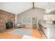 Cozy living room features a stone fireplace, wood floors, and a vaulted ceiling at 30819 Hilltop Dr, Evergreen, CO 80439