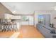 Bright open floor plan showcasing the living room, kitchen, and balcony access at 30819 Hilltop Dr, Evergreen, CO 80439