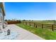 Backyard with a charming lawn and patio featuring white adirondack chairs and an open field view at 872 S Flat Rock Way, Aurora, CO 80018