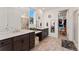 Bathroom featuring double sinks, walk in shower, and walk in closet with custom shelving at 872 S Flat Rock Way, Aurora, CO 80018