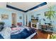 Bedroom features blue walls, fireplace, sewing machine table, and wolf blanket at 872 S Flat Rock Way, Aurora, CO 80018