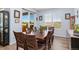 Dining room featuring a large table with seating for eight, a window, and access to the patio at 872 S Flat Rock Way, Aurora, CO 80018