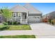 Charming home featuring a well-manicured lawn, gray two-car garage door, and inviting front porch at 872 S Flat Rock Way, Aurora, CO 80018