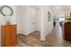 Bright hallway with wood floors, white walls, closet, and stylish decor, leading to dining area at 872 S Flat Rock Way, Aurora, CO 80018