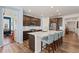 Open kitchen with large island, stainless steel appliances, and wooden cabinets, seamlessly connecting to living areas at 872 S Flat Rock Way, Aurora, CO 80018