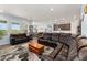 Open concept living room and kitchen with leather furniture and natural light at 872 S Flat Rock Way, Aurora, CO 80018