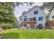 Beautiful backyard featuring a deck, a patio, lush greenery, and tasteful landscaping at 5260 Morning Glory Pl, Highlands Ranch, CO 80130